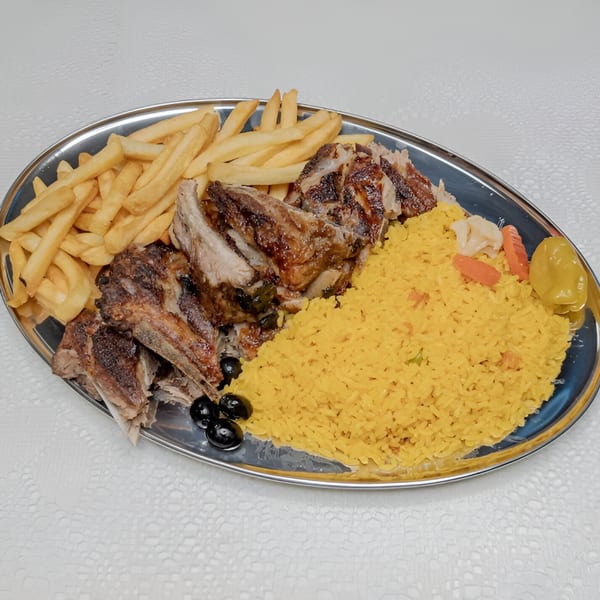 Fords BBQ ribs, yellow rice, french fries, and black olives on a silver platter.